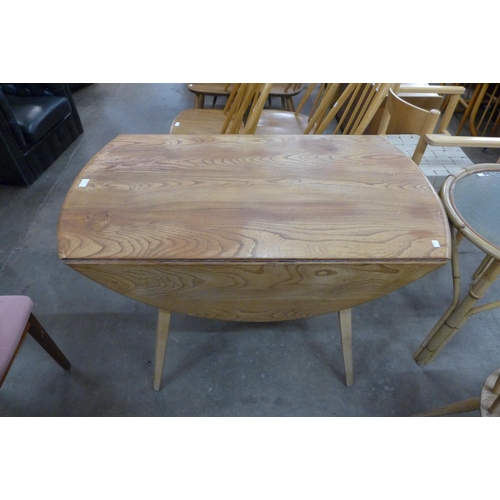 69 - An Ercol Blonde elm and beech drop leaf table