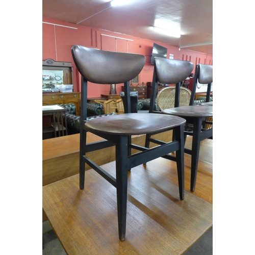 76 - A teak extending dining table and three chairs