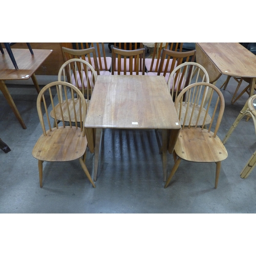 78 - An Ercol Blonde elm and beech drop leaf table and four Windsor chairs