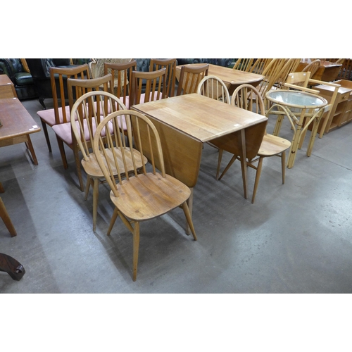 78 - An Ercol Blonde elm and beech drop leaf table and four Windsor chairs