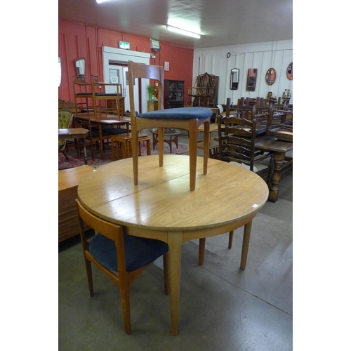 86 - A Nathan teak extending dining table and four chairs