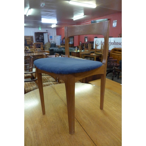 86 - A Nathan teak extending dining table and four chairs