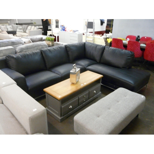 1525 - A black leather corner sofa on semi exposed chrome frame