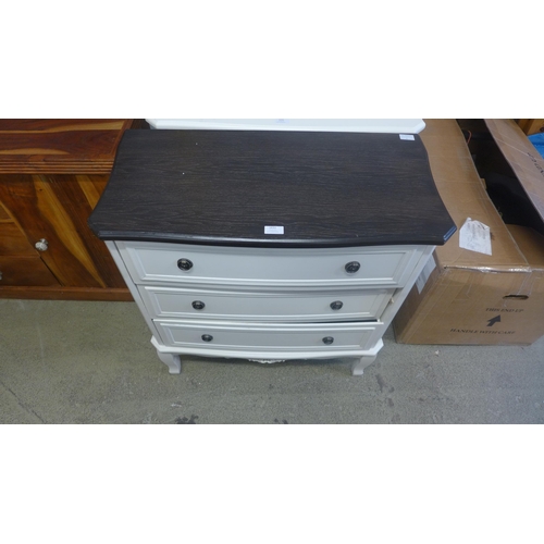 1632 - A three drawer chest with contrast top and a square chrome mirror (damaged)