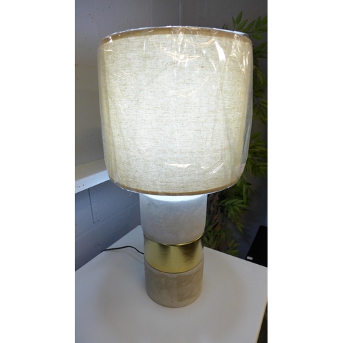 1316 - A concrete base table lamp with a decorative gold band and linen shade, H 63cms (70316743)   #