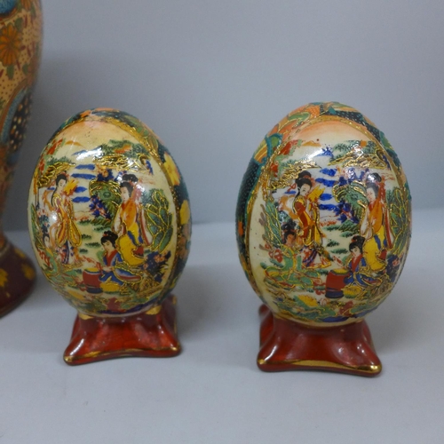 665 - A Japanese lidded vase and a pair of egg ornaments