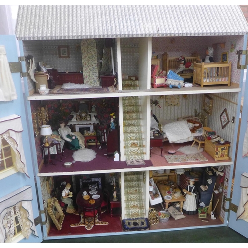 745 - A Georgian style dolls house, with furniture, accessories and dolls, electric set up **PLEASE NOTE T... 