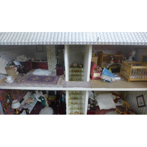 745 - A Georgian style dolls house, with furniture, accessories and dolls, electric set up **PLEASE NOTE T... 