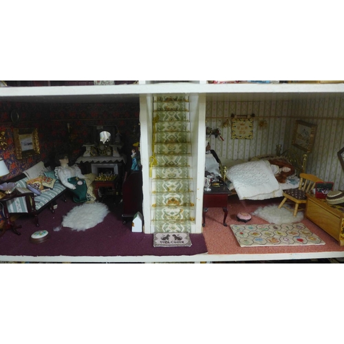 745 - A Georgian style dolls house, with furniture, accessories and dolls, electric set up **PLEASE NOTE T... 