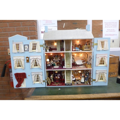 745 - A Georgian style dolls house, with furniture, accessories and dolls, electric set up **PLEASE NOTE T... 