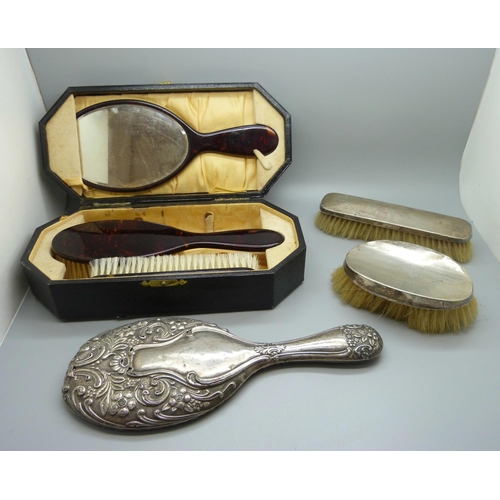 779 - A xylonite faux tortoiseshell vanity set, boxed, and three silver dressing table items, two brushes ... 