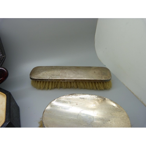 779 - A xylonite faux tortoiseshell vanity set, boxed, and three silver dressing table items, two brushes ... 