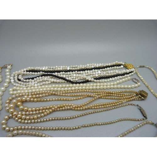 828 - A collection of pearls including a string of freshwater pearls and onyx, one string of seed pearls w... 