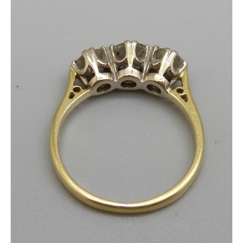 886 - An 18ct gold, three stone diamond ring, centre stone approximately 0.5ct weight, 3.1g, L