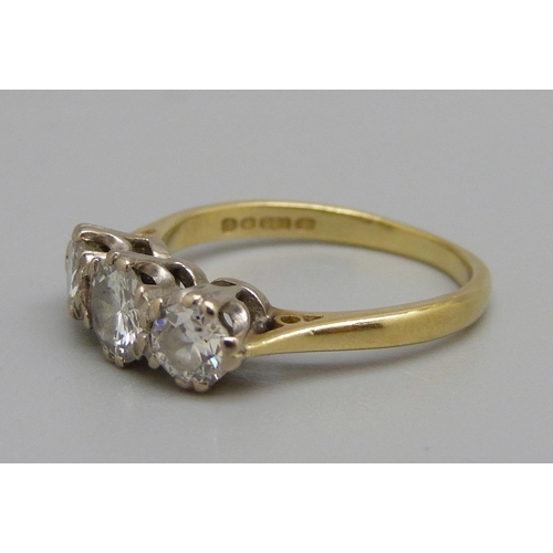 886 - An 18ct gold, three stone diamond ring, centre stone approximately 0.5ct weight, 3.1g, L