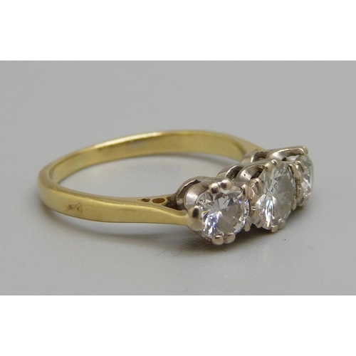 886 - An 18ct gold, three stone diamond ring, centre stone approximately 0.5ct weight, 3.1g, L