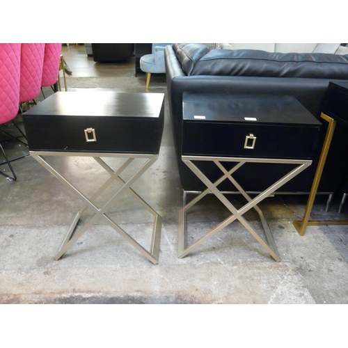 1485 - A pair of black bedside tables with cross legs