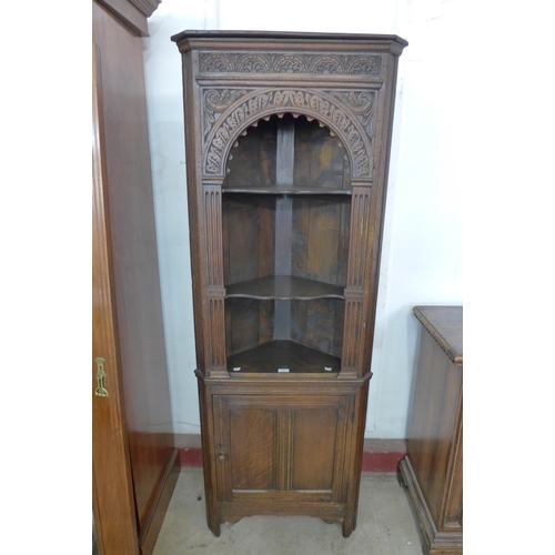 130 - A carved Ipswich oak freestanding corner cabinet