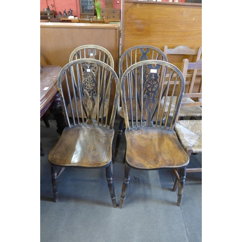 159 - A set of four elm and beech wheelback kitchen chairs