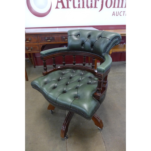 16 - A mahogany and green leather revolving Captain's desk chair