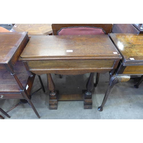 168 - An early 20th Century oak sewing box on a stand