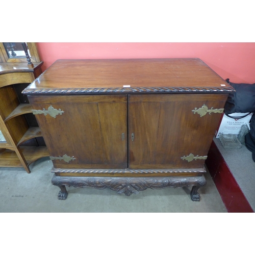 17 - An Edward VII Chippendale Revival carved mahogany press cupboard