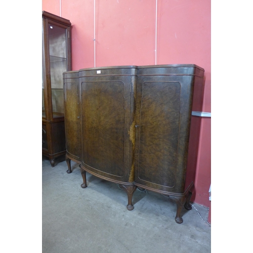 21 - An early 20th Century burr walnut three door enclosed bookcase