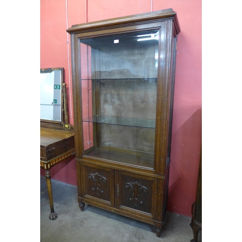 22 - A French carved oak display cabinet