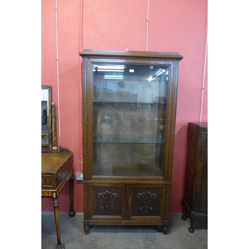 22 - A French carved oak display cabinet