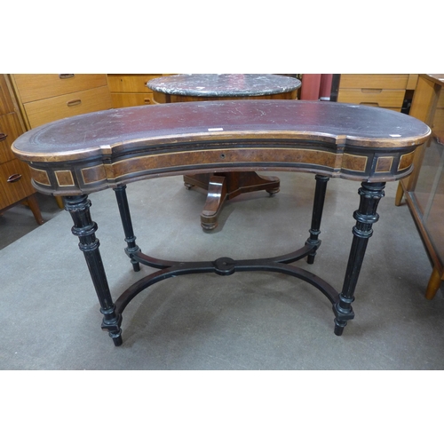 25 - A Victorian Gillows ambonya, ebonised and leather topped kidney shaped writing table