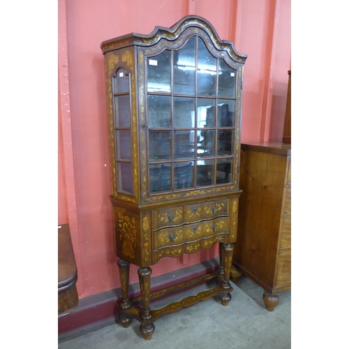 32 - A Dutch walnut and marquetry inlaid bookcase on stand