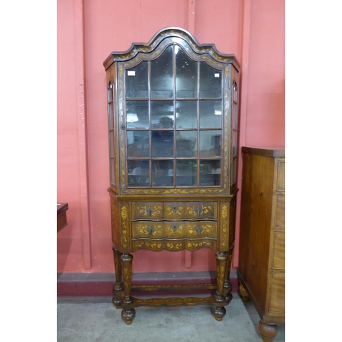 32 - A Dutch walnut and marquetry inlaid bookcase on stand