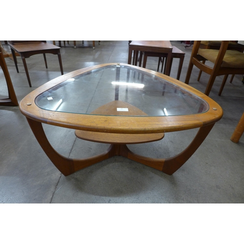 35 - A teak and glass topped triangular coffee table