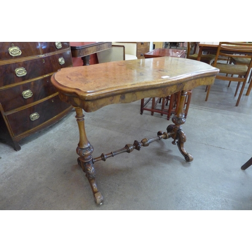 4 - A Victorian inlaid burr walnut serpentine fold over games table