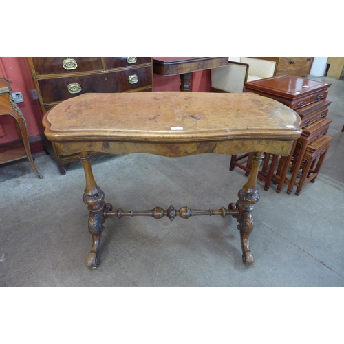 4 - A Victorian inlaid burr walnut serpentine fold over games table