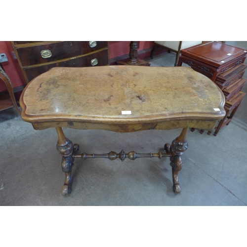 4 - A Victorian inlaid burr walnut serpentine fold over games table