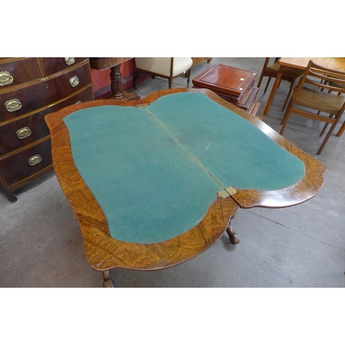 4 - A Victorian inlaid burr walnut serpentine fold over games table