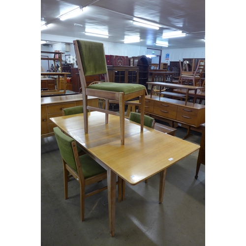 69 - A Gordon Russell walnut six piece dining suite, comprising; extending dining table, four chairs and ... 