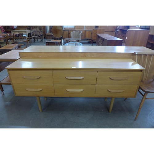 70 - A teak six drawer sideboard