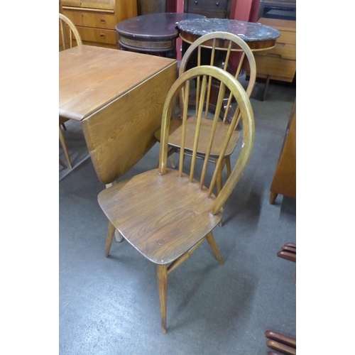 88 - An Ercol Blonde elm and beech Windsor drop-leaf table and four chairs