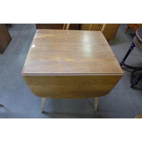 88 - An Ercol Blonde elm and beech Windsor drop-leaf table and four chairs