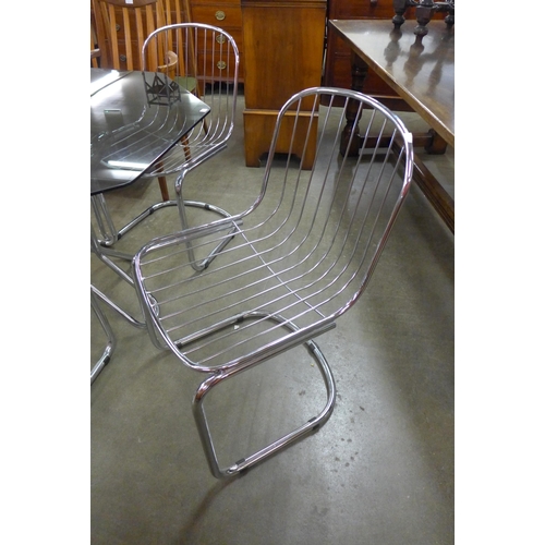 89 - An Italian chrome and smoked glass octagonal dining table and four chairs