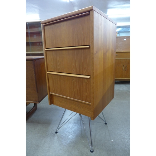 58 - A teak chest of drawers on chrome stand