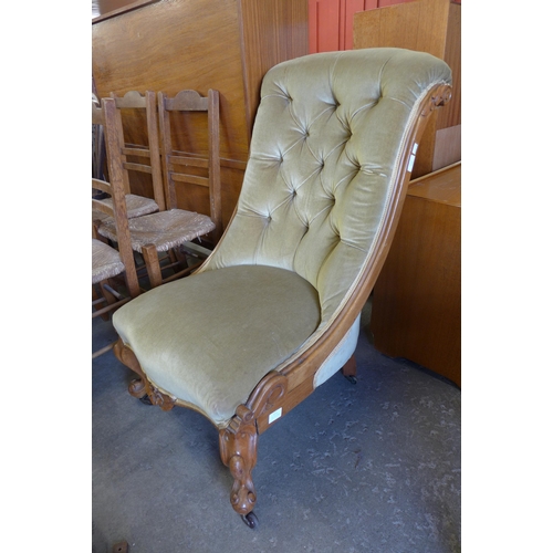 142 - A Victorian carved walnut and green fabric upholstered lady's chair