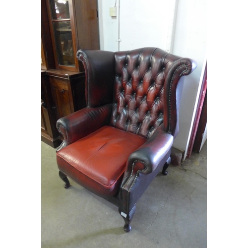 222a - An oxblood red Chesterfield wingback armchair