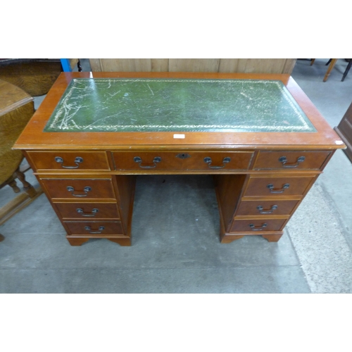 184 - A mahogany and green leather topped pedestal desk