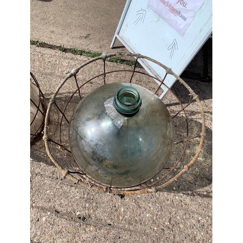 2072 - Glass carboy jar in metal cage