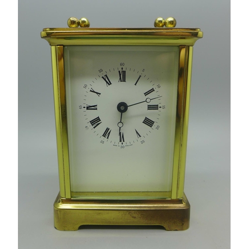 630 - A brass and four glass sided carriage clock, with keys, (purchased from Pragnells of Stratford Upon ... 