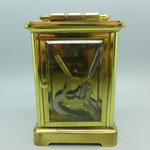 630 - A brass and four glass sided carriage clock, with keys, (purchased from Pragnells of Stratford Upon ... 