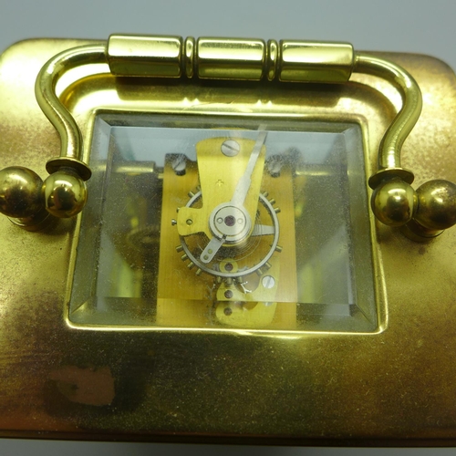 630 - A brass and four glass sided carriage clock, with keys, (purchased from Pragnells of Stratford Upon ... 